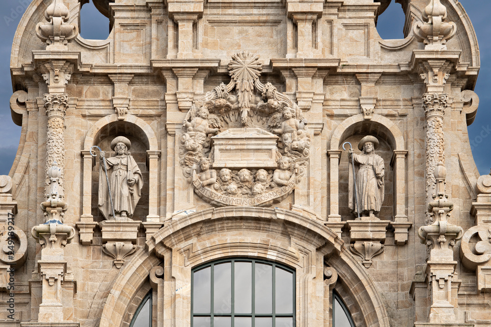 Santiago de Compostela cathedral facade detail with two sculptures of saint James and the tomb. Baroque facade detail. Ancient architecture