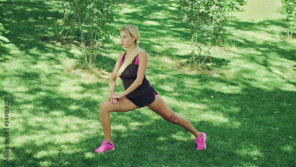 Young woman doing stretching squat while warm up before training. Fitness woman Young woman doing stretching squat while warm up before training. Fitness woman