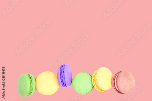 Delicious macarons on pink background