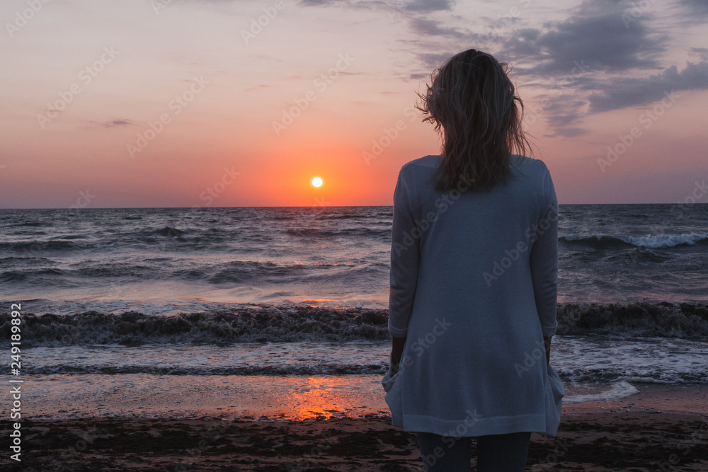 beautiful girl on the beach meets the dawn over the sea beautiful girl on the beach meets the dawn over the sea