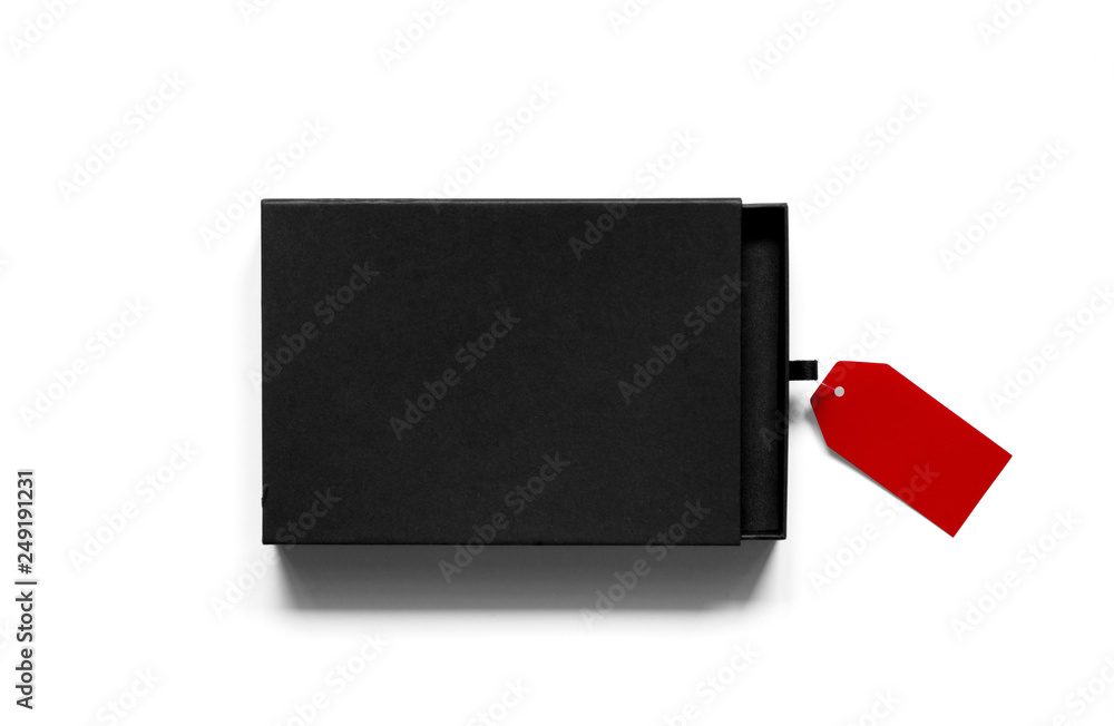 Flatlay of black cardboard box with red label on white background.