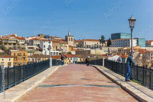 People on the historic bridge of Zamora, Spain