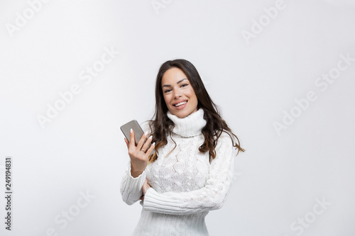 beautiful young woman in a studio with a cell phone