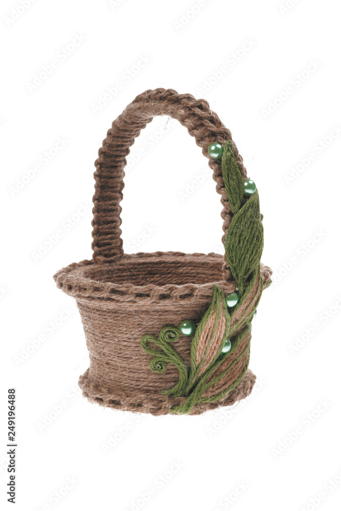 Basket decorated with leaves and beads, handmade from jute thread isolated on a white background. Basket decorated with leaves and beads, handmade from jute thread isolated on a white background.