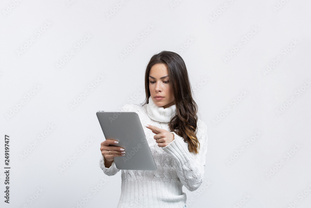 beautiful young woman in a studio with a tablet showing something beautiful young woman in a studio with a tablet showing something