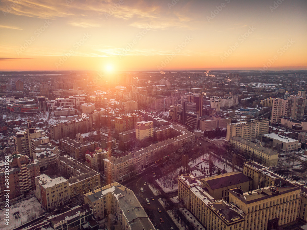 Aerial view of winter midtown of Voronezh city with buildings, roads and skyline at sunset