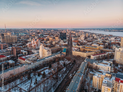 Aerial shot of winter Voronezh midtown at sunset evening time, old city architecture buildings, roads and car traffic © DedMityay