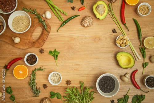 Variety of herbs, spices, fruits and vegetables on the wooden table