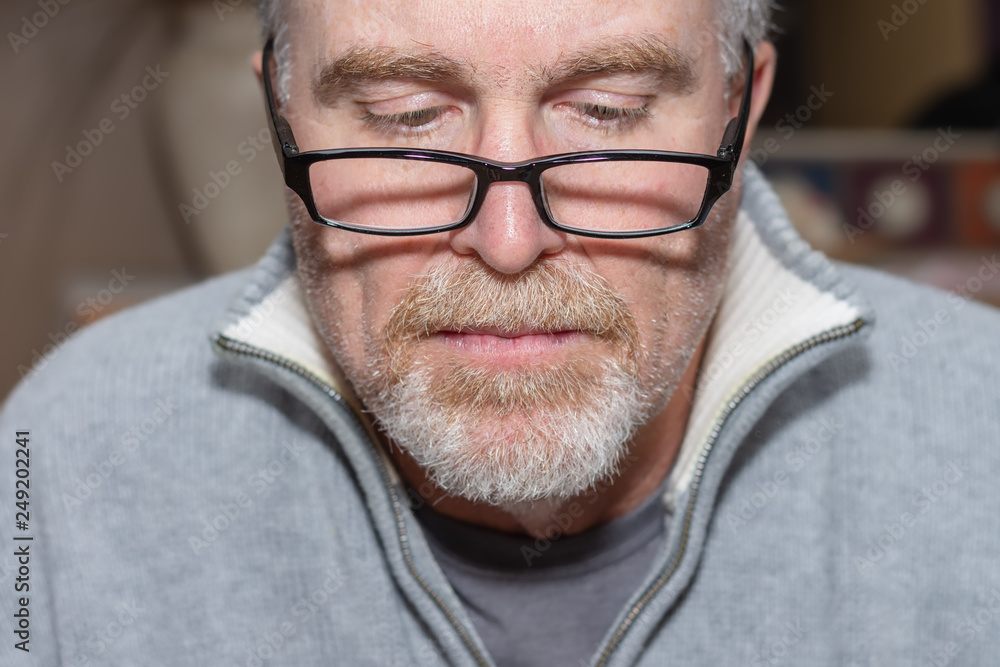 senior man reading an old book with glasses on nose Stock Photo | Adobe  Stock