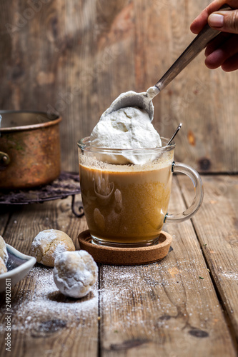 Pumpkin spice latte with a dollop of cream and some cookies