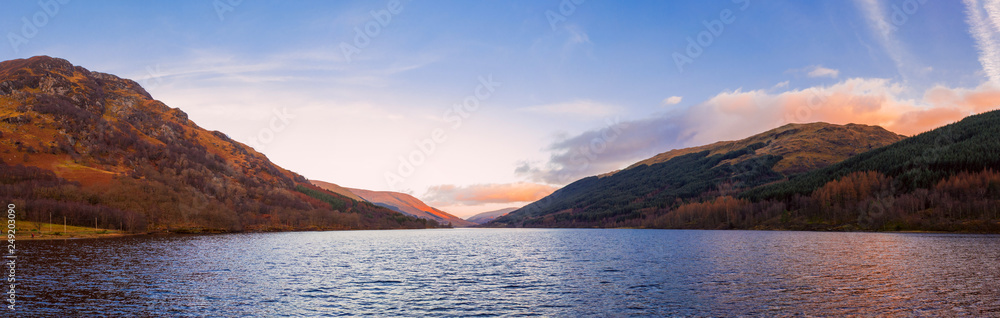 Scottish beautiful colorful sunset landscape with Loch Voil, mountains and forest at Loch Lomond & The Trossachs National Park