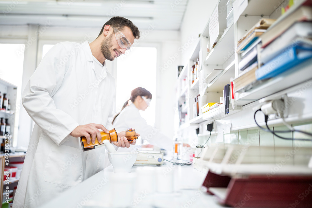 Man and woman working in laboratory of a pharmacy Man and woman working in laboratory of a pharmacy