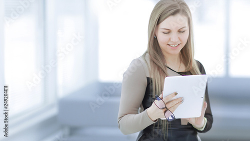 young business woman with digital tablet on blurred office background