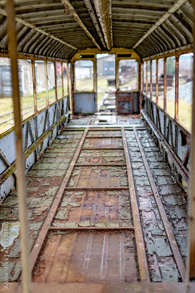 Old rusty wagon of the narrow gauge railway. Place of stationing of old steam locomotives.