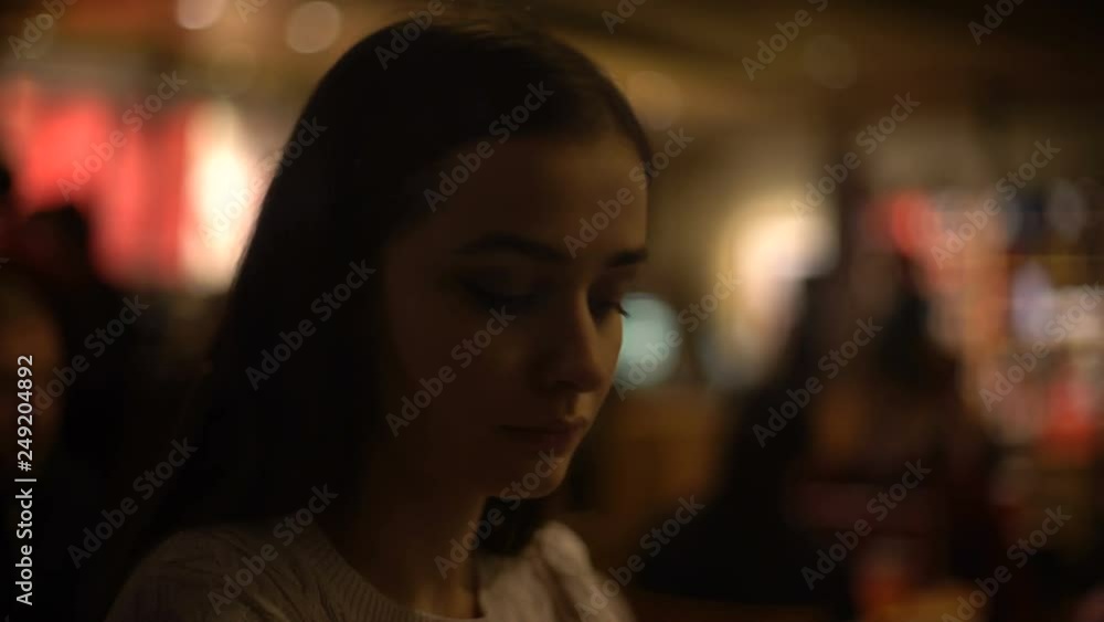 Beautiful female sitting in bar, relaxation after working day, waiting friend Beautiful female sitting in bar, relaxation after working day, waiting friend