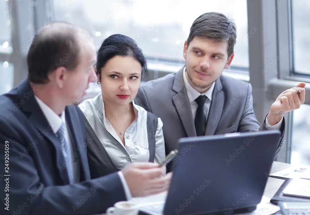rear view.group of business people using laptop in office rear view.group of business people using laptop in office