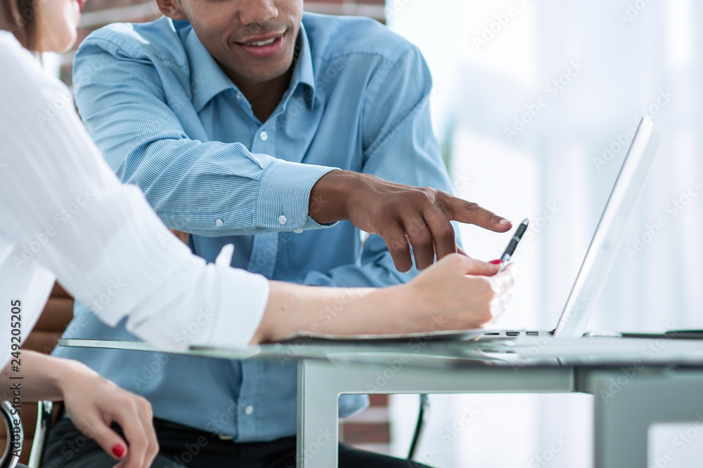 employees talking to a customer sitting at the Desk employees talking to a customer sitting at the Desk