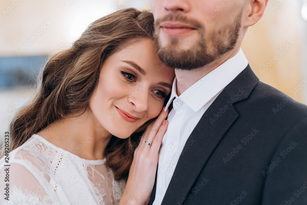 Classic portrait of lovely wedding couple, bride leaned to her husband Classic portrait of lovely wedding couple, bride leaned to her husband