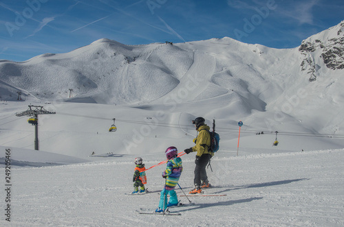Stunning view of the mountains and skiers family in Obertauern ski resort