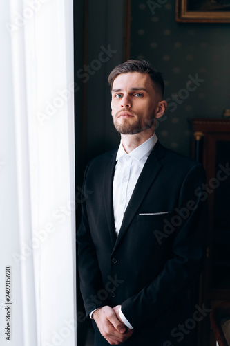 Portrait of handsome serious stylish groom