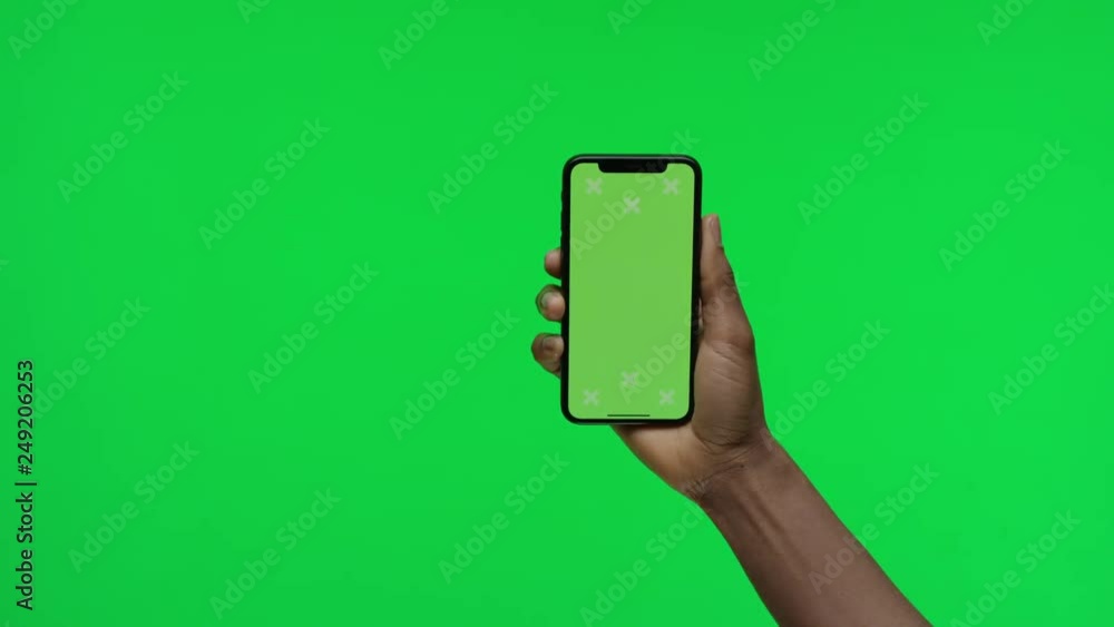 Female hand holding smart device on green screen chroma background making gestures, zoom in, pinch, swipe, scroll Female hand holding smart device on green screen chroma background making gestures, zoom in, pinch, swipe, scroll