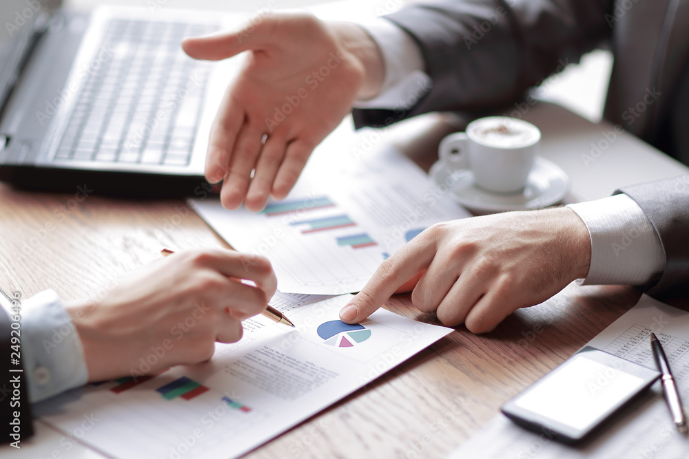 business people and partners are analyzing sales figures this y
