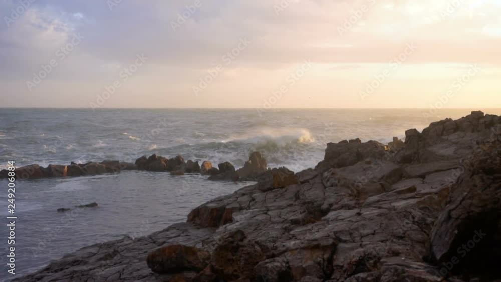 Huge waves break on the stones, slow motion Huge waves break on the stones, slow motion