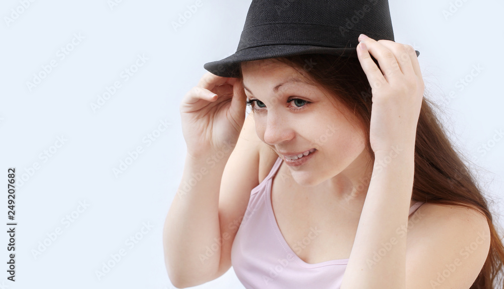 smiling young woman in black hat.isolated on a white smiling young woman in black hat.isolated on a white