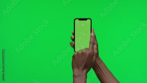 Female Hand holding Green Screen Smartphone swipe left 2 times