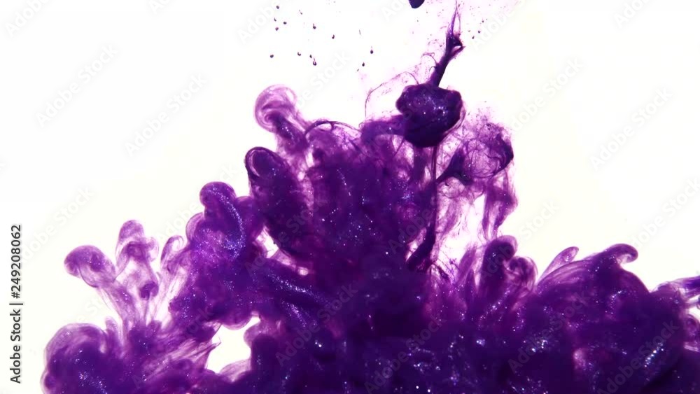 A purple shiny ink drop in slow motion in water on white for a smokey colorful abstract background.