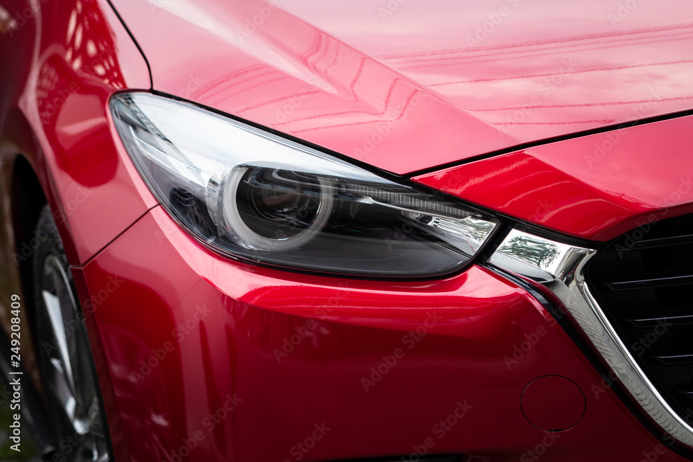 Closeup of headlight red car.