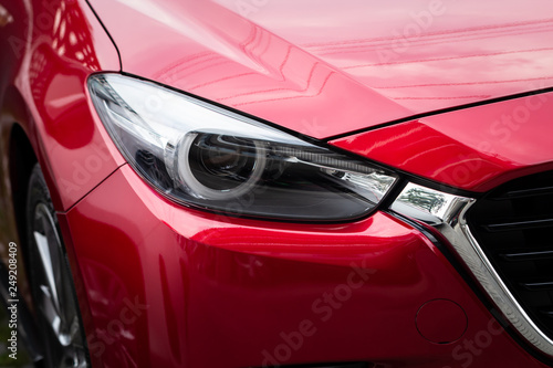 Closeup of headlight red car.