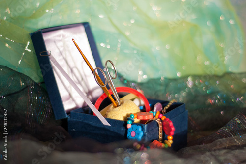 blue box with multi-colored accessories for needlework