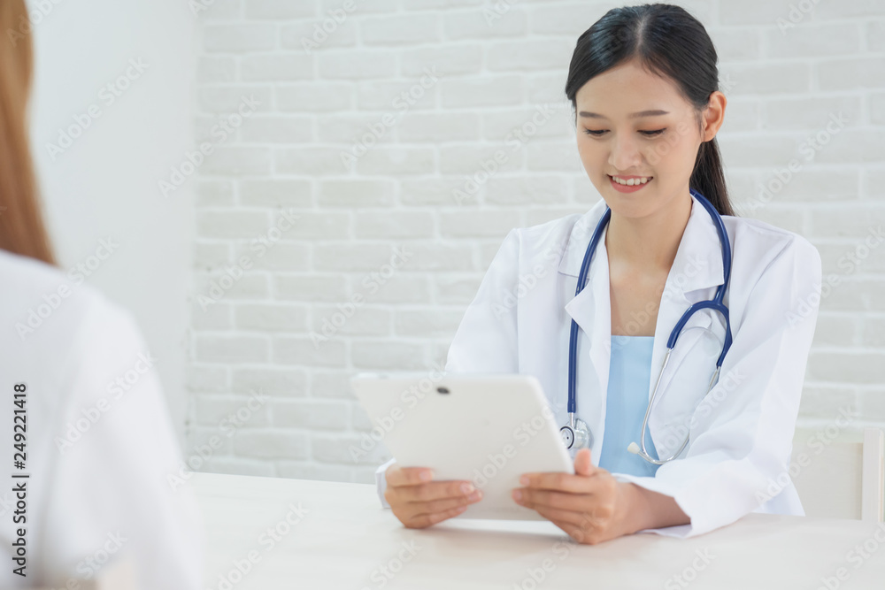 Female doctor talking to patient.Doctor and patient discussing something while sitting at the table . Medicine and health care concept. Doctor and patient Female doctor talking to patient.Doctor and patient discussing something while sitting at the table . Medicine and health care concept. Doctor and patient
