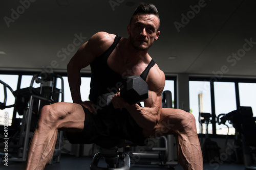 Bodybuilder Exercising Biceps With Dumbbells © Jale Ibrak