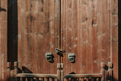Traditional Chinese wooden doors with lion head door knocker and locks, in the old town of Wuzhen, China