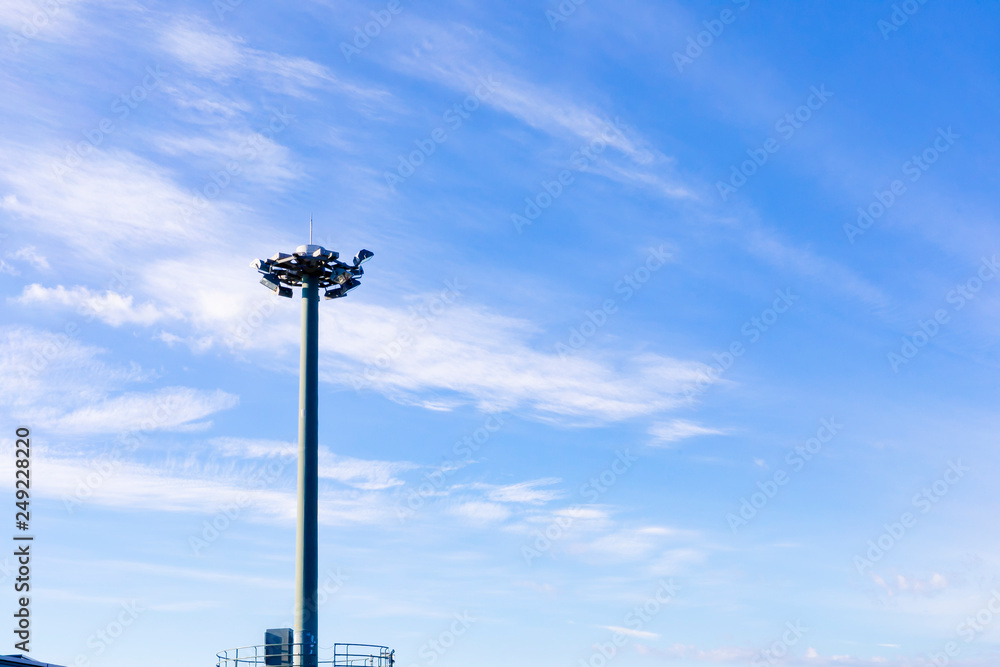 Light pole with blue sky on background