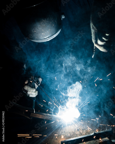 Man welding iron with a protective mask © Pavko