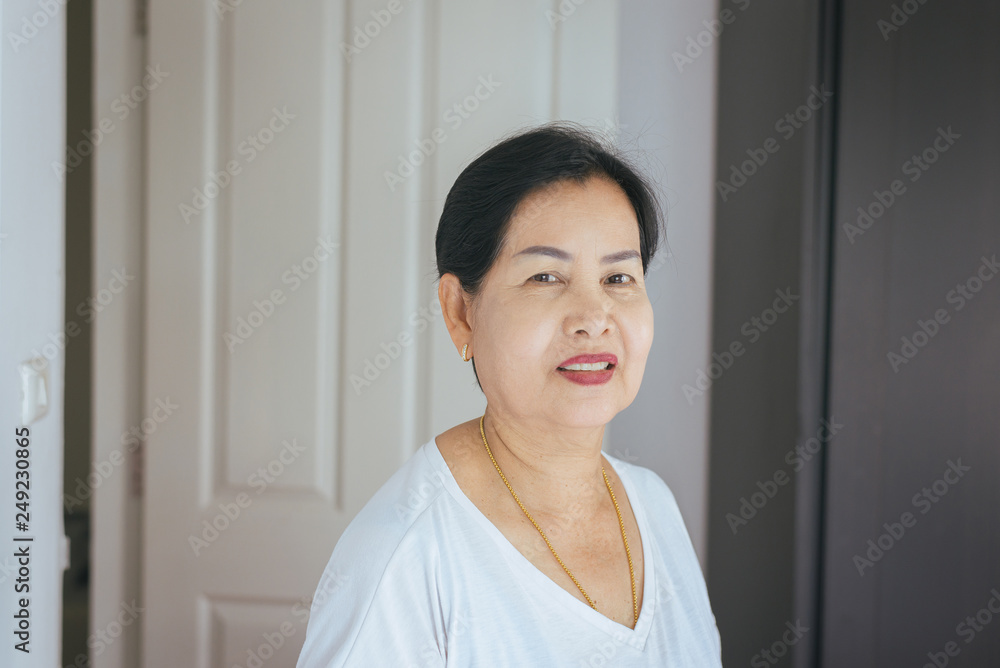 Portrait beautiful elderly asian woman in room,Senior female happy and smiling,Lifestyle concept,Positive thinking Portrait beautiful elderly asian woman in room,Senior female happy and smiling,Lifestyle concept,Positive thinking