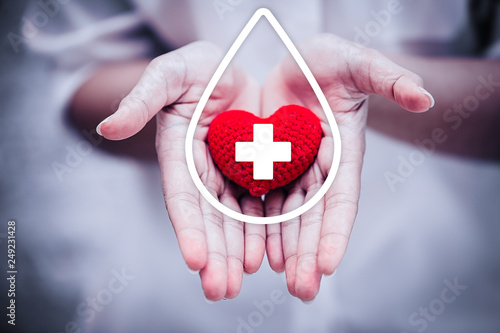 Obraz na plátne hand giving red heart for help blood donation hospital or healthcare concept