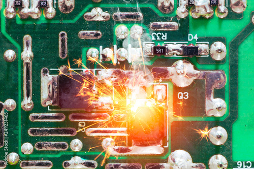Electricity circuit short burn out overheat chip on the PCB. photo