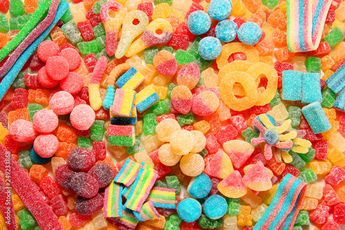 Assorted variety of sour candies includes extreme sour soft fruit chews, keys, tart candy belts and straws. photo