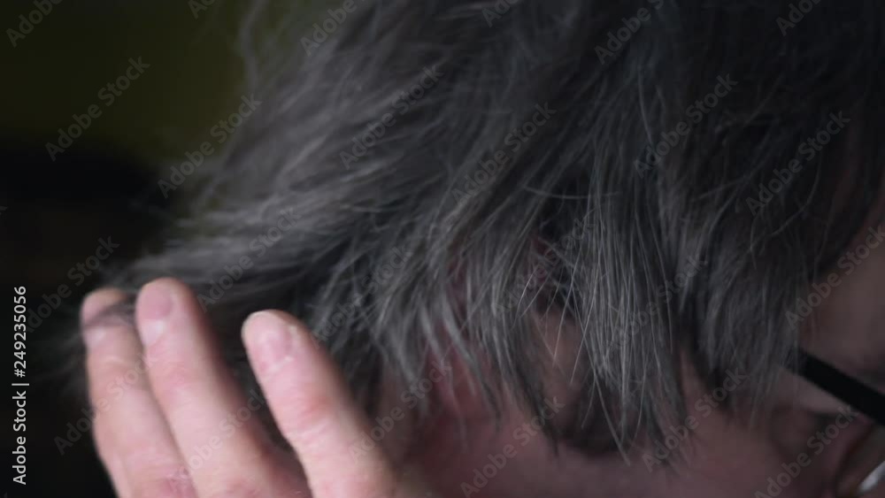 Men starting to have grey hair, passing his hand between hair. Aging concept. Men starting to have grey hair, passing his hand between hair. Aging concept.