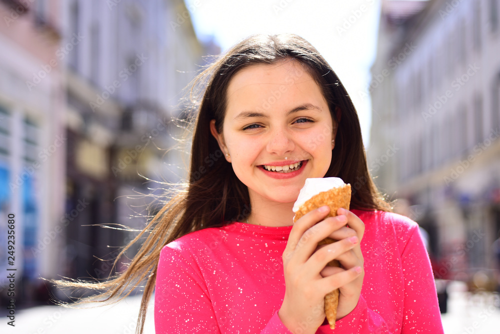 Enjoying frozen food snack or dessert. Cute girl smiling with ice cream. Pretty girl hold ice cream cone on summer day. Happy girl child eating ice cream in hot weather. The taste is great