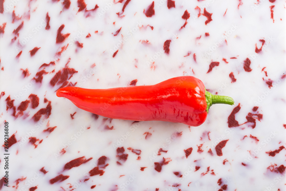 Sweet red pepper on textured plastic background, top view Sweet red pepper on textured plastic background, top view