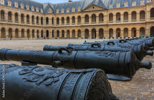Detail of old cannons at the Court of Honor in Les Invalides army museum in Paris, France burial site for many of France's war heroes, also housing the tomb of the emperor Napoleon Bonaparte