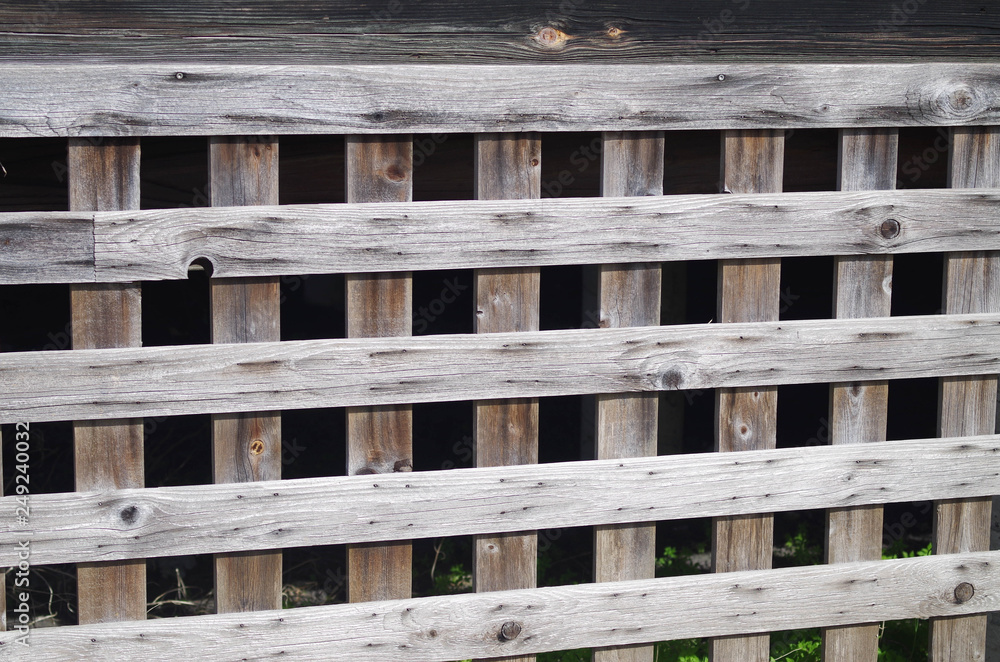 Weathered cedar latticework building skirting Weathered cedar latticework building skirting