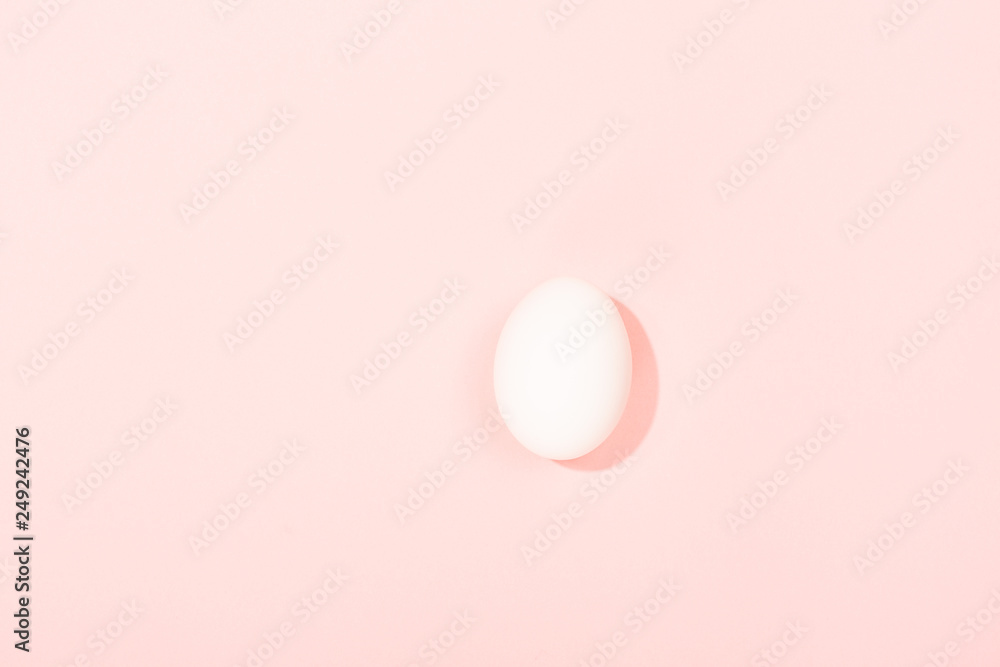 One egg on pink background
