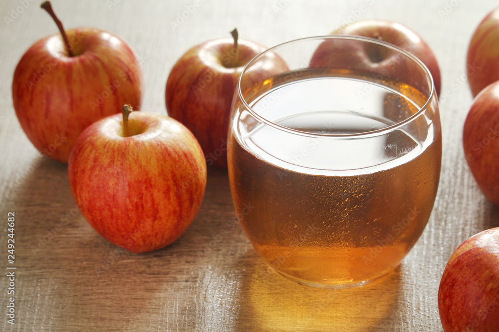 A glass with juice and apples A glass with juice and apples