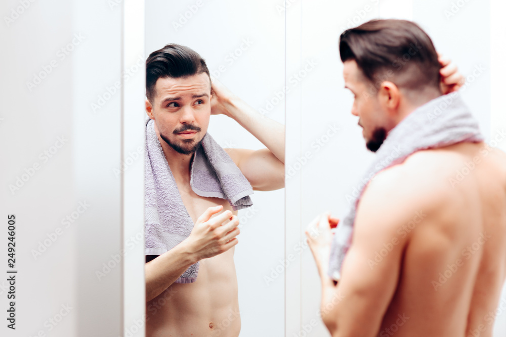 Handsome Man Checking Himself in the Mirror Handsome Man Checking Himself in the Mirror